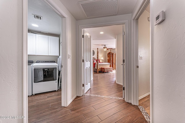 corridor featuring hardwood / wood-style floors and washer and dryer