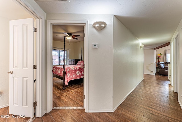 hallway featuring hardwood / wood-style floors and a textured ceiling