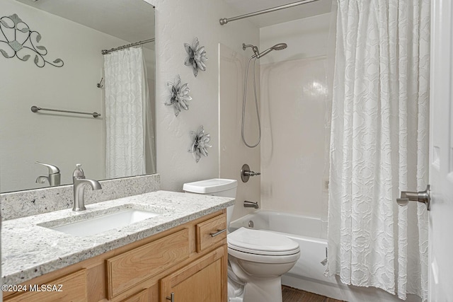 full bathroom with vanity, shower / tub combo, and toilet