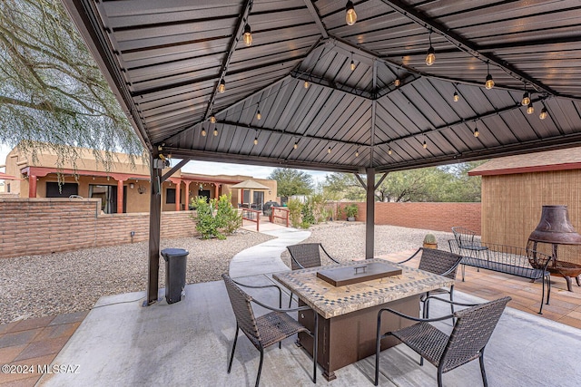 view of patio with a fire pit and a gazebo