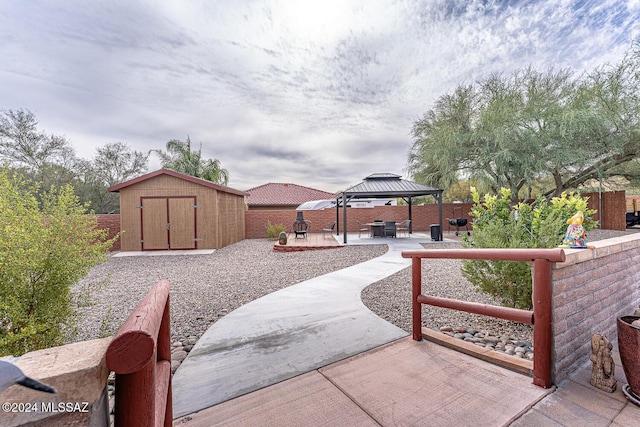 exterior space with a gazebo and a storage unit