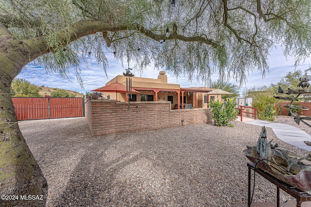 back of property with a patio