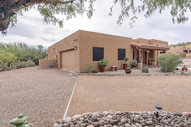 southwest-style home featuring a garage