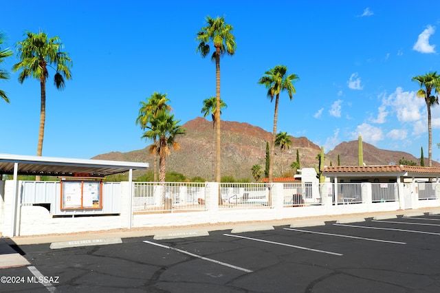 view of car parking featuring a mountain view