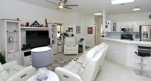 tiled living room with ceiling fan