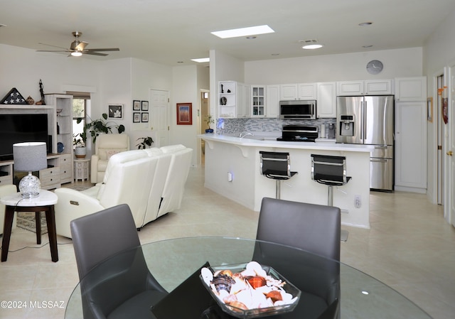 dining area featuring ceiling fan and light tile patterned floors