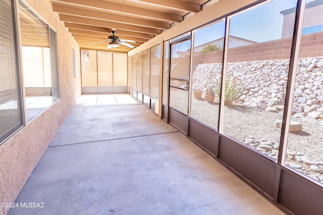 unfurnished sunroom with ceiling fan