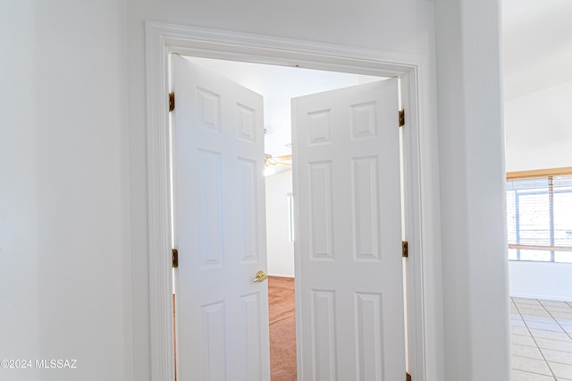 corridor featuring light colored carpet