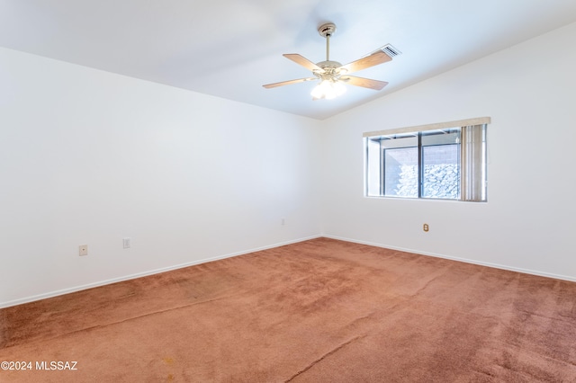 carpeted empty room featuring lofted ceiling and ceiling fan