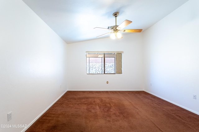 carpeted spare room featuring ceiling fan and vaulted ceiling