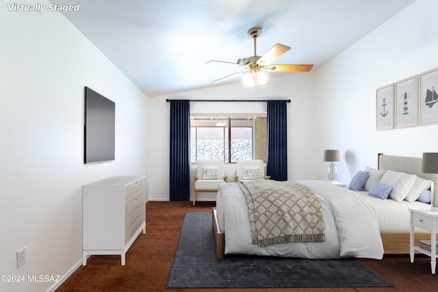 carpeted bedroom with ceiling fan and vaulted ceiling