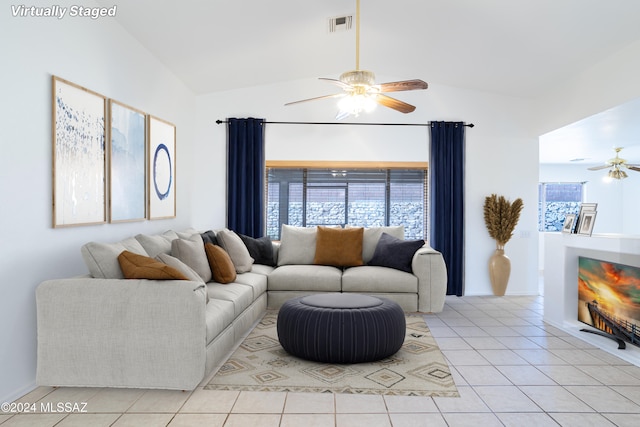 living room with light tile patterned flooring, ceiling fan, and lofted ceiling