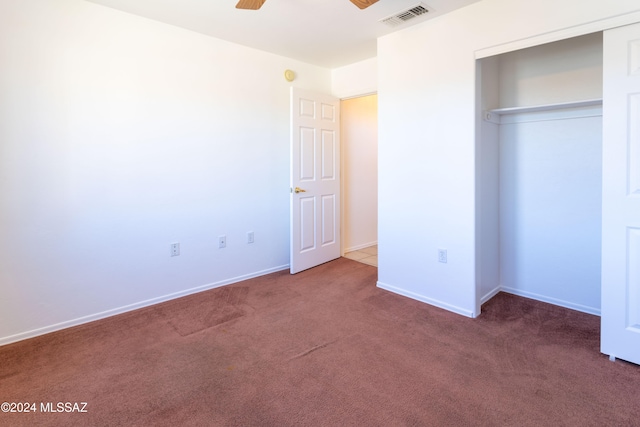 unfurnished bedroom featuring ceiling fan, a closet, and carpet floors