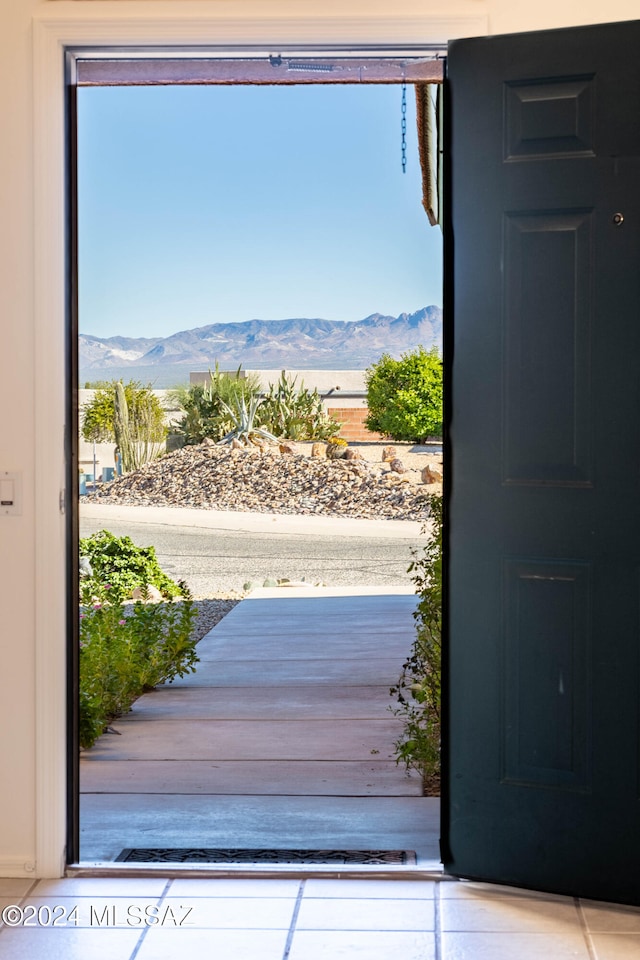 doorway to outside featuring a mountain view and a healthy amount of sunlight