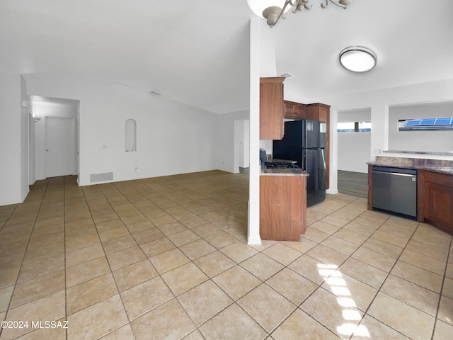 kitchen with dishwasher, black fridge, light tile patterned floors, and an inviting chandelier