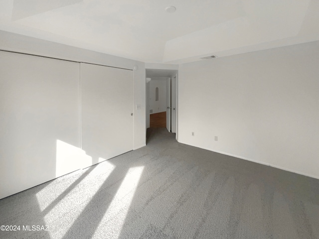 unfurnished bedroom featuring a closet and carpet