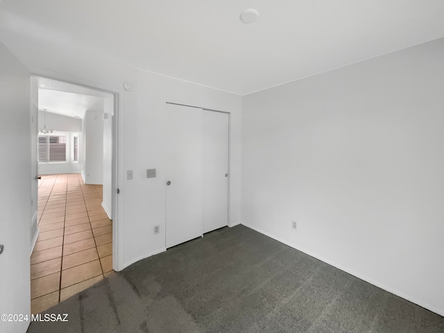 empty room with lofted ceiling and dark carpet