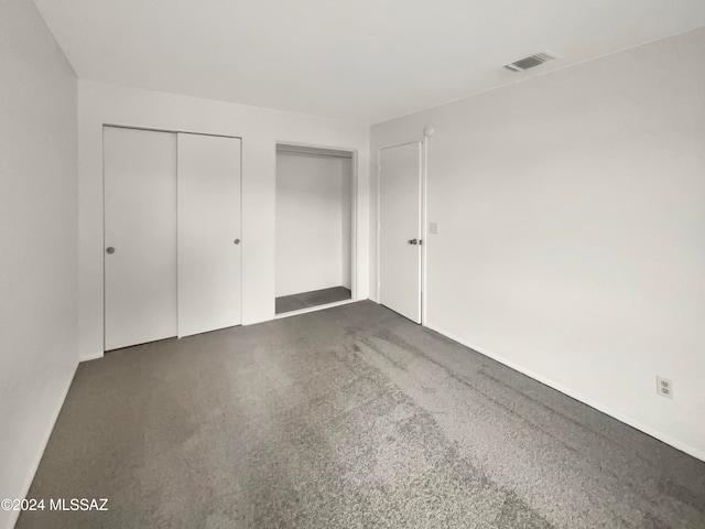 unfurnished bedroom featuring dark carpet