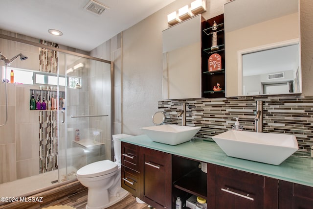 bathroom featuring vanity, hardwood / wood-style flooring, toilet, and tasteful backsplash