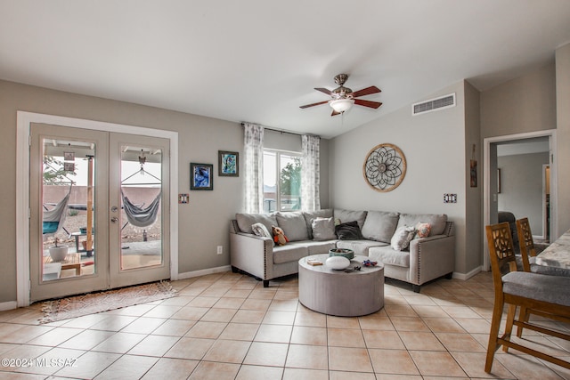 tiled living room with ceiling fan and vaulted ceiling