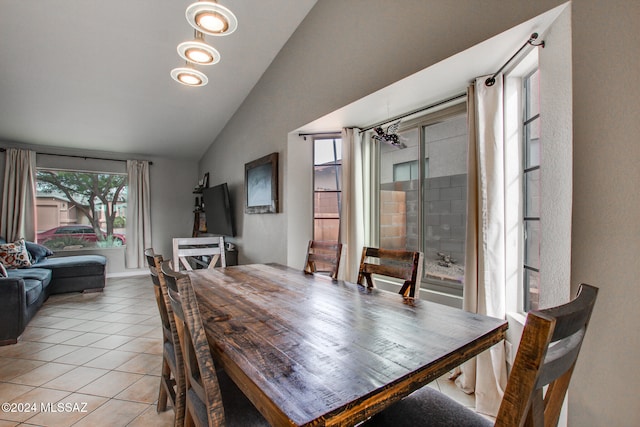 tiled dining area with lofted ceiling