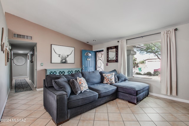 living room featuring light tile patterned flooring and vaulted ceiling