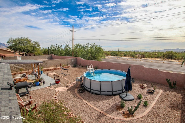 view of yard with a patio area and a fenced in pool