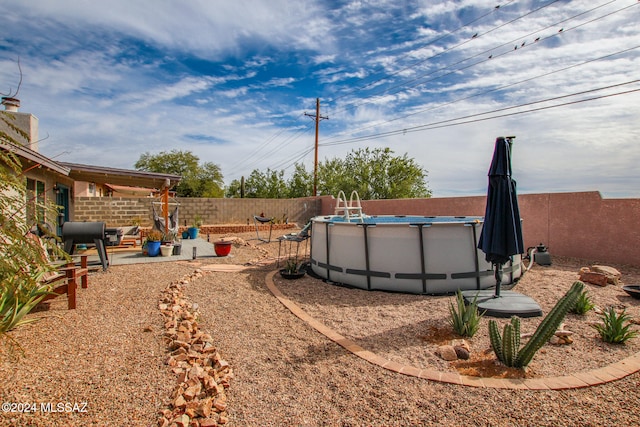 view of yard with a fenced in pool