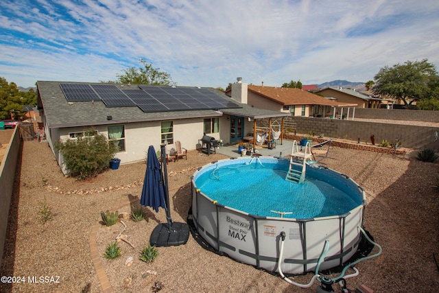 view of swimming pool featuring a grill and a patio area