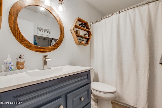 bathroom with tile patterned floors, vanity, and toilet