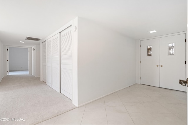 entrance foyer featuring light carpet