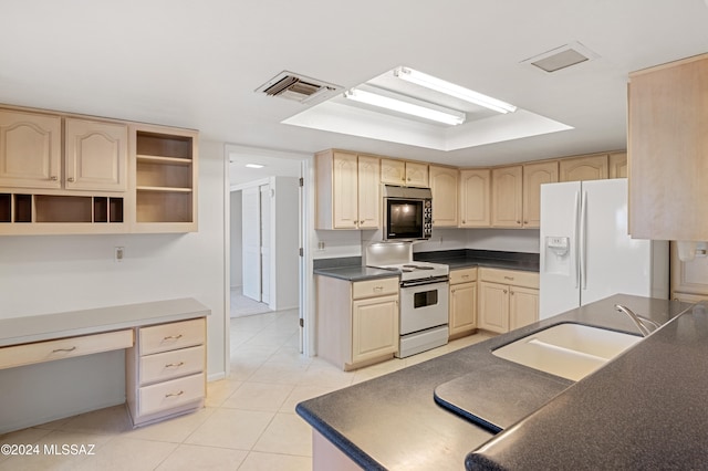 kitchen with light brown cabinetry, white appliances, sink, and light tile patterned floors