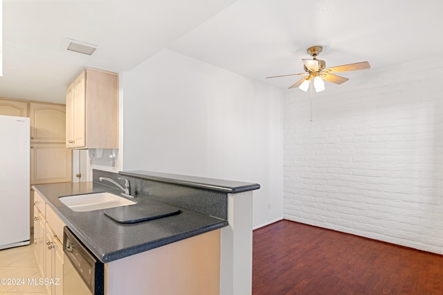 kitchen featuring light brown cabinetry, dark hardwood / wood-style flooring, stainless steel dishwasher, sink, and white refrigerator