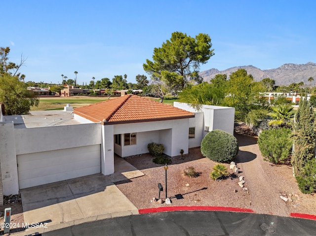 view of front of property with a mountain view and a garage