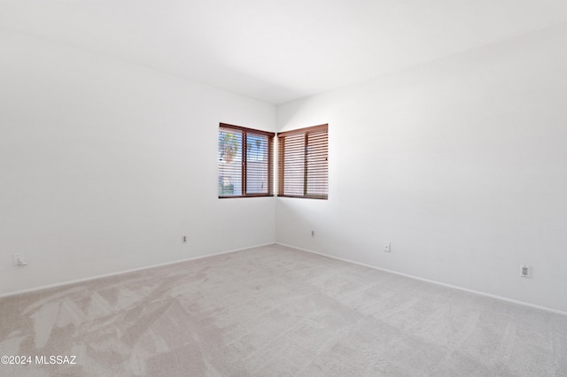 unfurnished room with light carpet