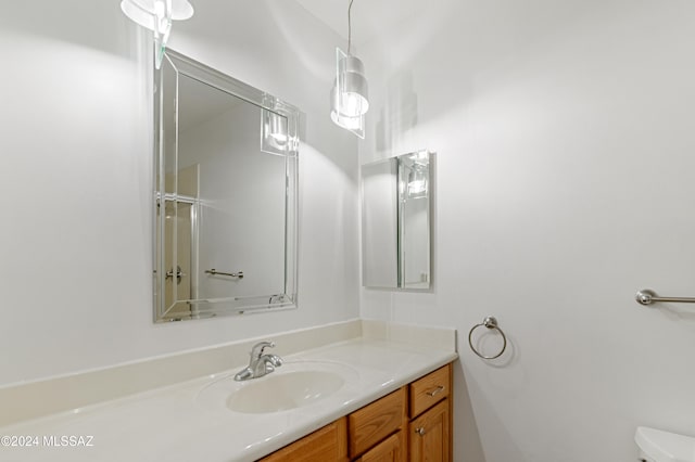 bathroom featuring vanity and toilet