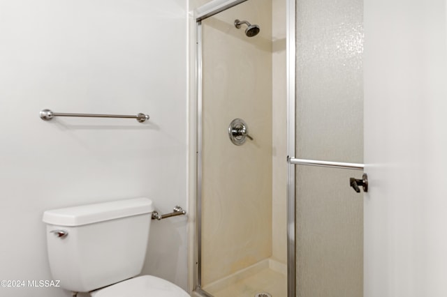 bathroom featuring toilet and walk in shower