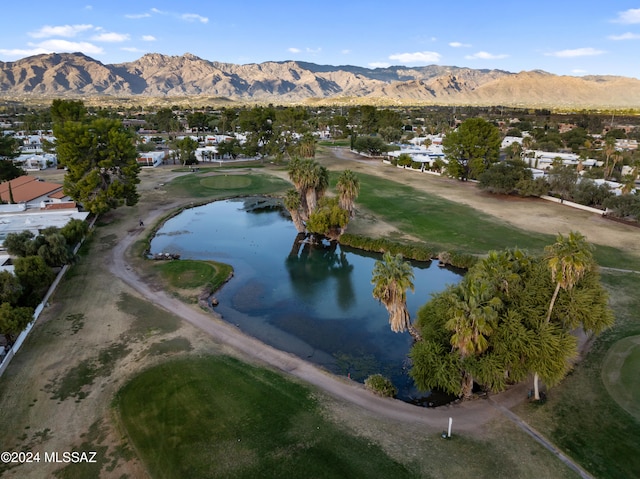 birds eye view of property with a water and mountain view