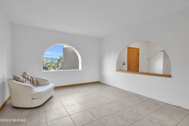 unfurnished room featuring light tile patterned floors