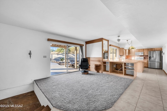 tiled living room featuring ceiling fan