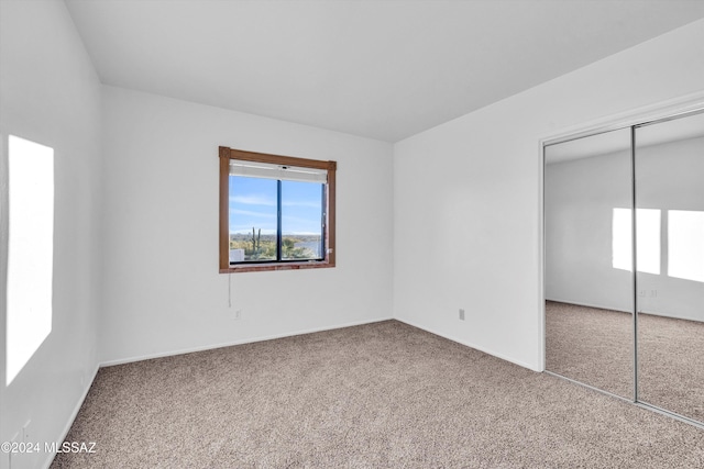 unfurnished bedroom with a closet and carpet