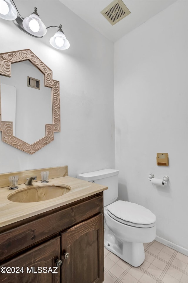 bathroom featuring toilet and vanity