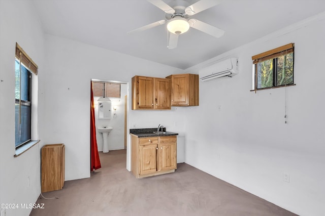 kitchen featuring light colored carpet, an AC wall unit, ceiling fan, and sink