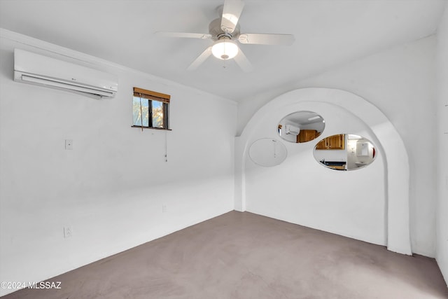 unfurnished room featuring a wall mounted AC and ceiling fan