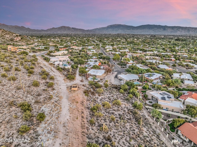 aerial view at dusk featuring a mountain view