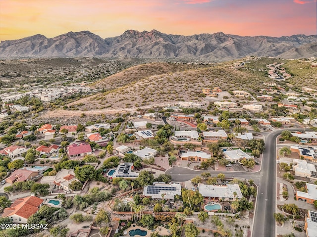 aerial view at dusk featuring a mountain view