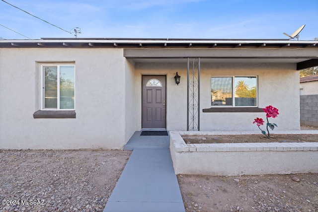 doorway to property with a porch