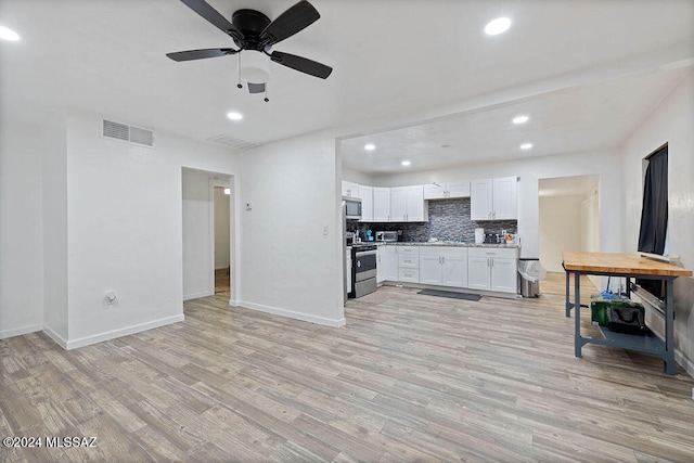 kitchen featuring ceiling fan, light hardwood / wood-style flooring, backsplash, white cabinets, and appliances with stainless steel finishes