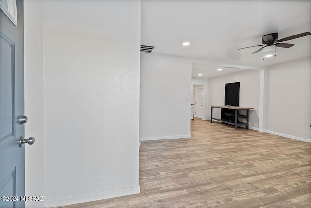 unfurnished living room featuring light wood-type flooring and ceiling fan