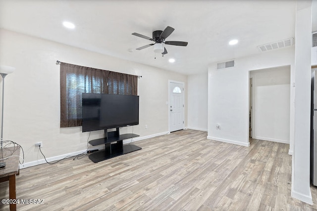 unfurnished living room featuring ceiling fan and light hardwood / wood-style floors